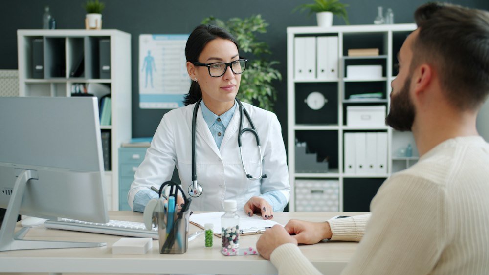 A physician talking with a patient during an office visit